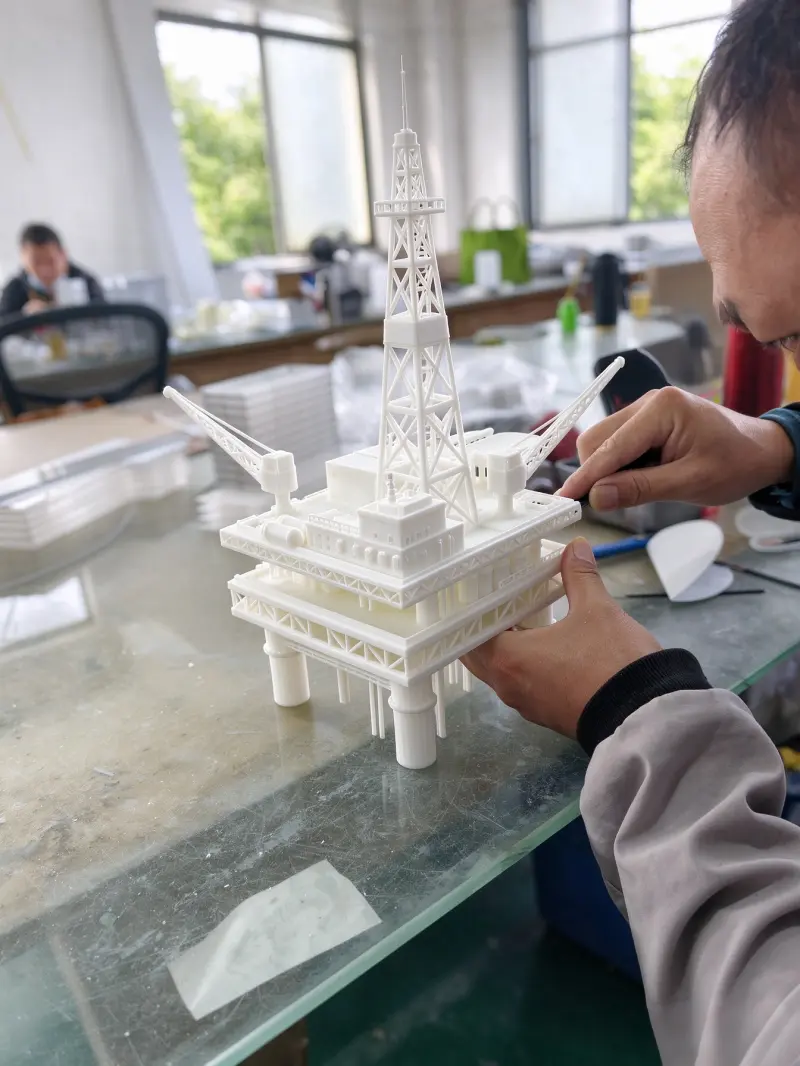 Factory workshop scene, skilled worker assembling custom precision scale model for engineering exhibition and tender display.
